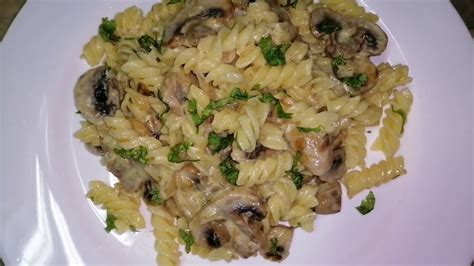 Fusilli pasta in creamy mushrooms sauce. Delicious Italian recipe ...