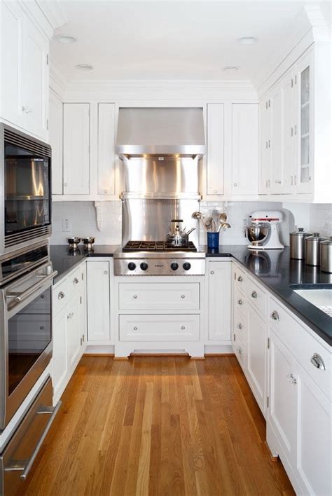 small kitchen design white U shaped kitchen black countertops wood ...