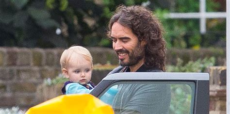 Russell Brand Cradles Precious Daughter During Stroll With Wife