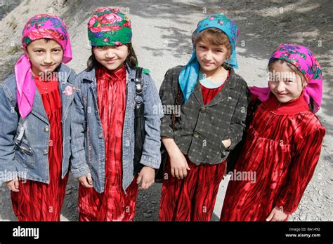 Tajik girls wearing traditional dresses and headscarf, Marguzor Stock ...