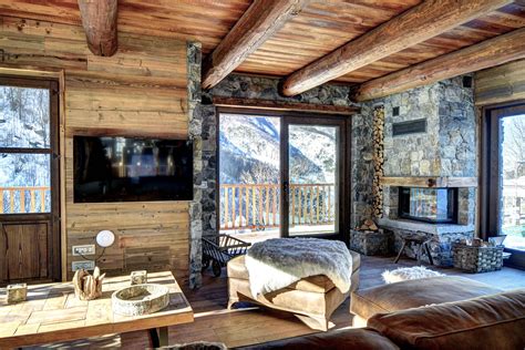 Ski chalet living room with leather sofa, fireplace, wooden floor and ...