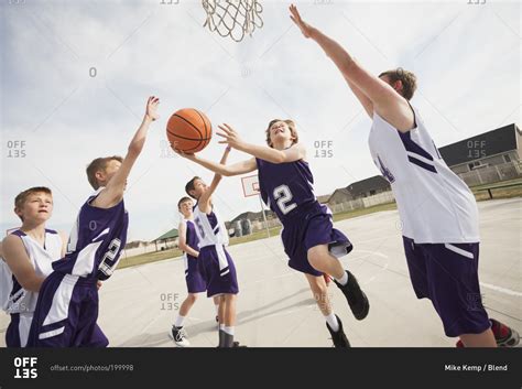 Group of children playing basketball stock photo - OFFSET