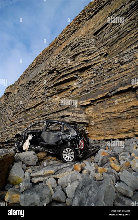 Car at bottom of cliff Stock Photo - Alamy