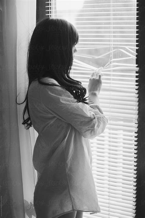 "Black And White Photo Of A Young Woman Looking Through The Window" by ...