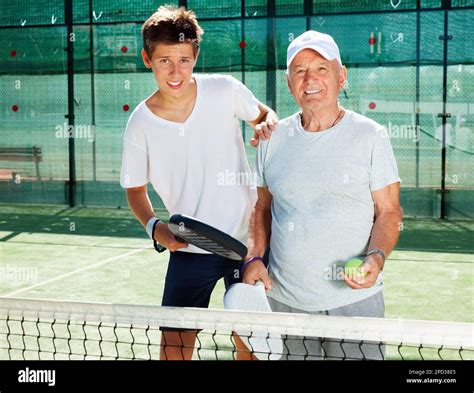 padel players of different generations posing on padel court Stock ...