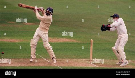 Wicket keeper Nayan Mongia leaps as Jack Russell knocks a four during ...