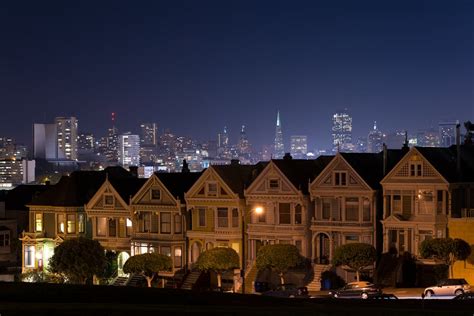 Illuminated Suburban Street with City Skyline in Background · Free ...