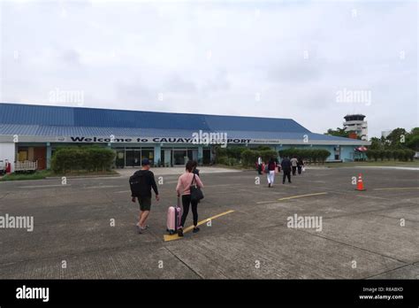 Passengers on their way to the terminal of Cauayan Airport after ...