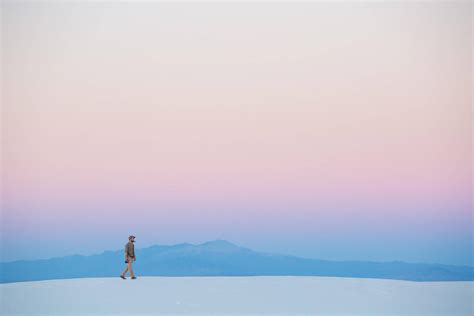 Download Minimalist Desktop Man Walking On Sand Wallpaper | Wallpapers.com