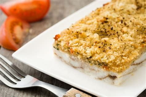 Premium Photo | White fish casserole with cheese on wooden.