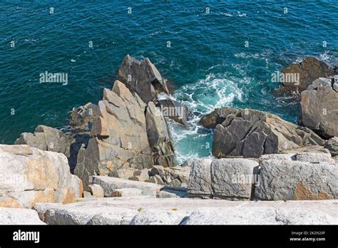 Jagged Rocks Below a Steep Ocean Cliff Stock Photo - Alamy