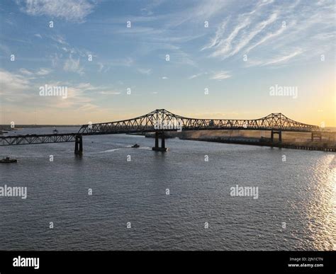 An aerial view of a metal bridge above the Mississippi river at sunset ...