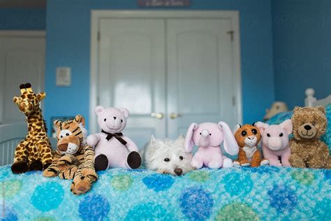 «Cute Dog Laying On A Child's Bed Among Stuffed Animals» del ...