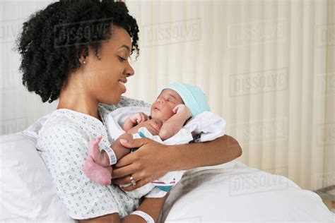 Smiling black mother holding newborn baby in hospital - Stock Photo ...