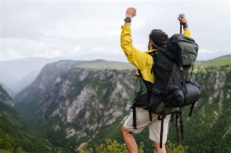 Young man traveling with backpack hiking in mountains | The Swiss ...