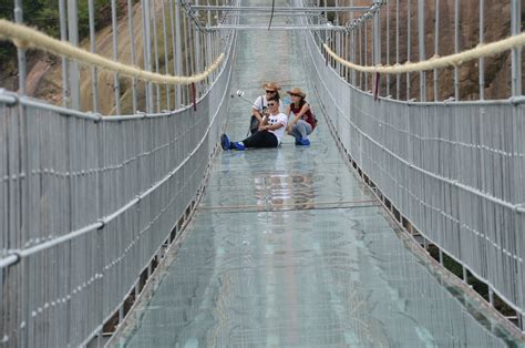 This terrifying 4,000ft-high glass bridge 'cracks' as you walk along it ...