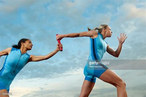 Runners passing baton in relay race | Relay races, Sport portraits ...