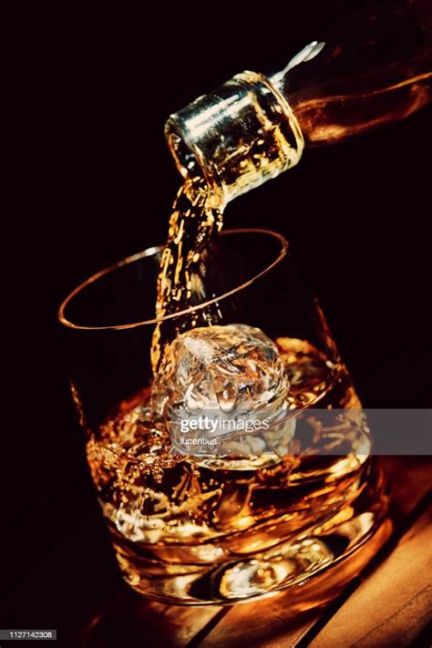 Pouring A Glass Of Whiskey On Ice High-Res Stock Photo - Getty Images