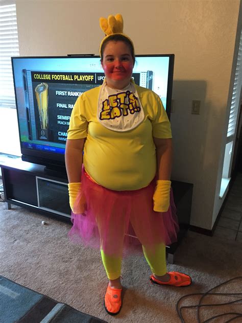 a woman dressed as a clown standing in front of a tv