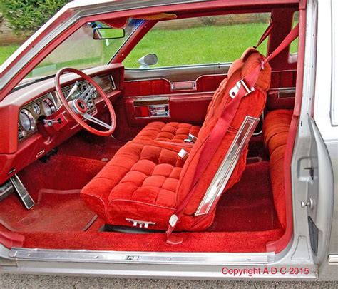 the interior of an old car with red upholstered seats