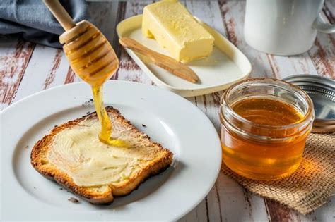 Premium Photo | Preparing a healthy breakfast with a toast with butter ...