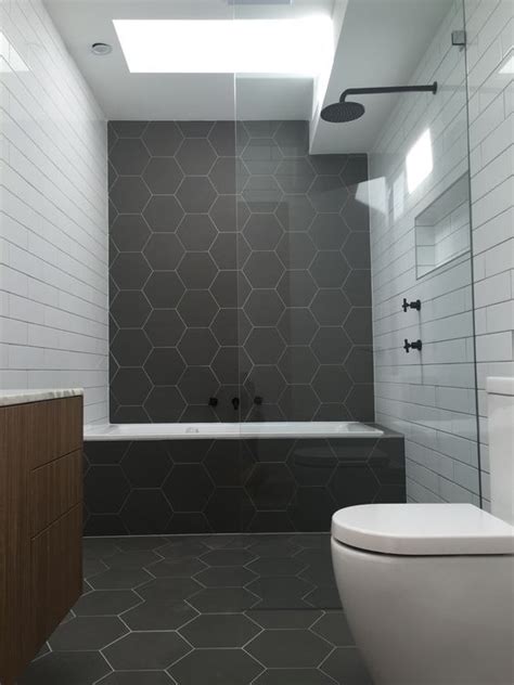 matte graphite grey hexagon tiles and white subway ones create an ...