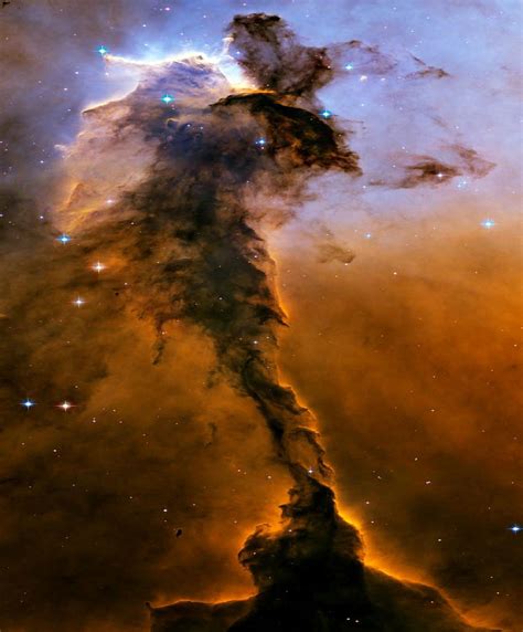 An image of the Eagle Nebula reveals a tall, dense tower of gas being ...