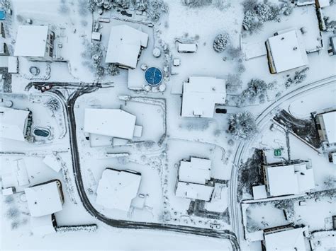 Premium Photo | Aerial view of town with snow covered houses. roof tops ...