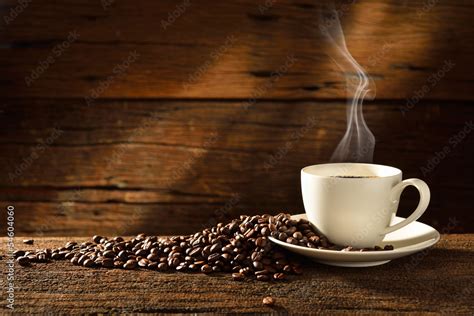 Coffee cup and coffee beans on old wooden background Stock Photo ...