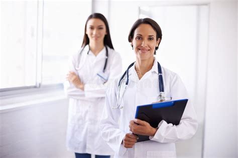 Theyre Ready To Help You. Portrait of a Pair of Confident Young Doctors ...