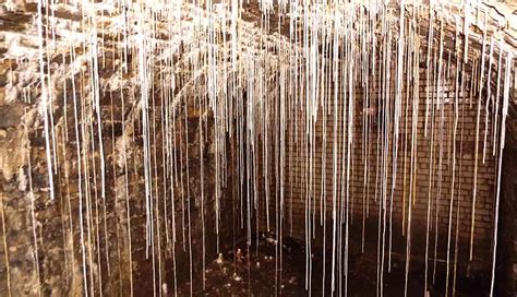 Speleothem growth in caves vs man-made structures