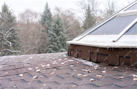 Premium Photo | Snow falling on the roof