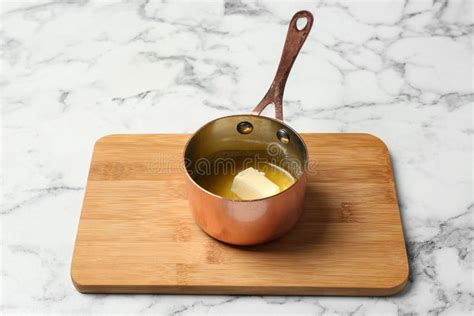 Saucepan with Melting Butter on Marble Background, Top View. Stock ...