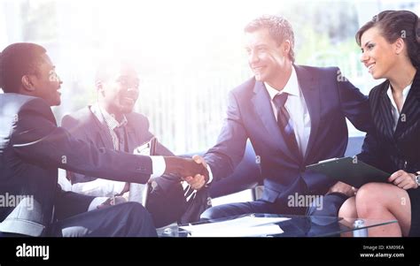 Business people shaking hands at a meeting Stock Photo - Alamy