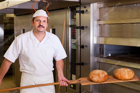 Male baker baking bread Stock Photo by ©Kzenon 68463471