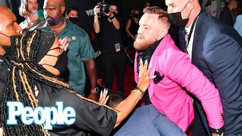 Conor McGregor Takes a Swing at Machine Gun Kelly During Altercation on ...