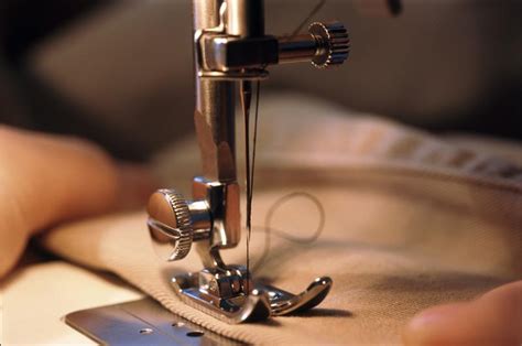 Free image of Close up of hands and sewing machine needle