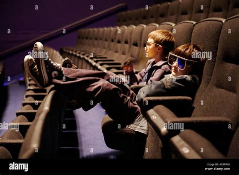 Two boys watching an Imax movie, with 3D glasses on Stock Photo - Alamy