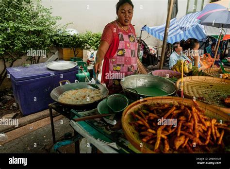 BANGKOK, THAILAND - MAY 3, 2014: Thai lady prepares street food in ...