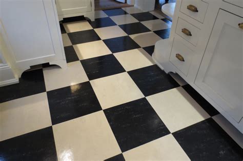 a kitchen with black and white checkered flooring, cabinets and drawers ...