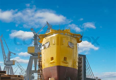 The construction of a new ship in dry dock shipyard | Stock image ...