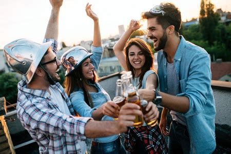 Group of happy friends having party on rooftop - Stock Image - Everypixel