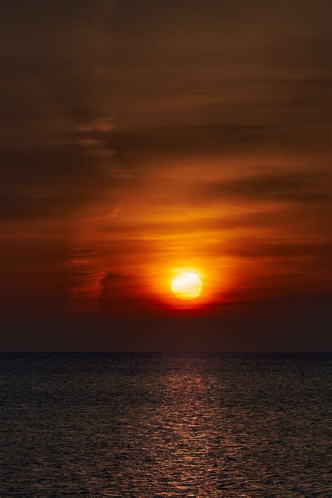 Download wallpaper 3761x5641 sunset, sun, horizon, glare, sky, water hd ...