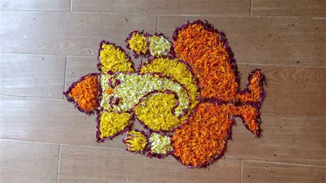 Lord Ganesh rangoli design in marigold flowers by Janya's creation ...