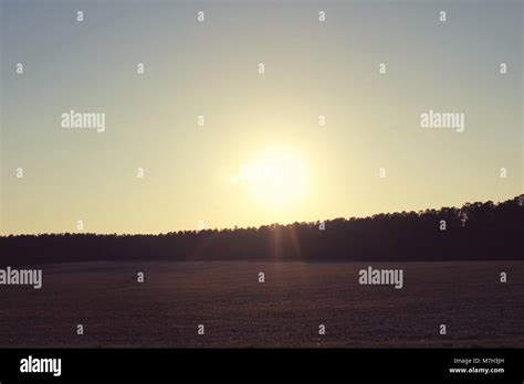 A farm field at sunset Stock Photo - Alamy