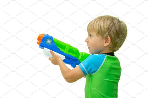 Boy holds water gun isolated on containing water gun, background, and ...