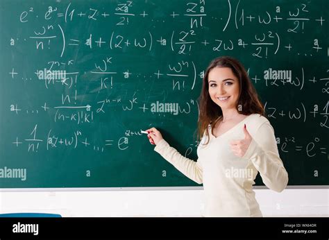 Young female math teacher in front of chalkboard Stock Photo - Alamy