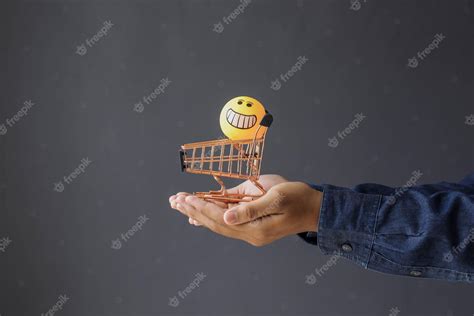 Premium Photo | Closeup of consumers hand giving a mini shopping cart ...