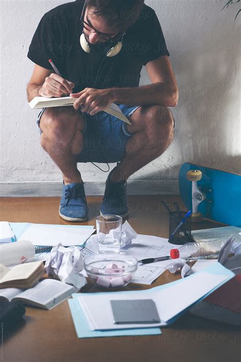 "Young Casual Man Studying With Notes And Books On The Floor." by ...