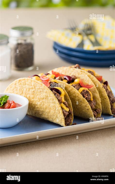 Mexican tacos with beef, cheddar cheese, tomato Stock Photo - Alamy